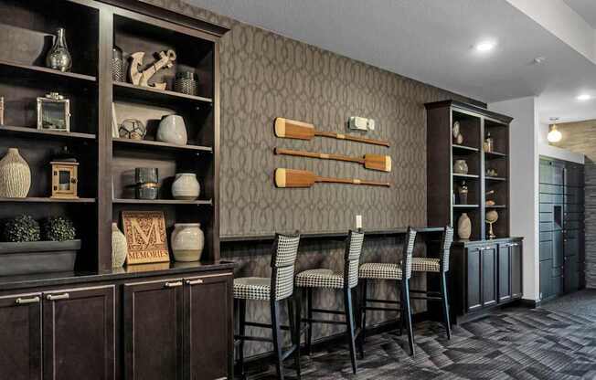 A room with a brown cabinet and a grey wall.