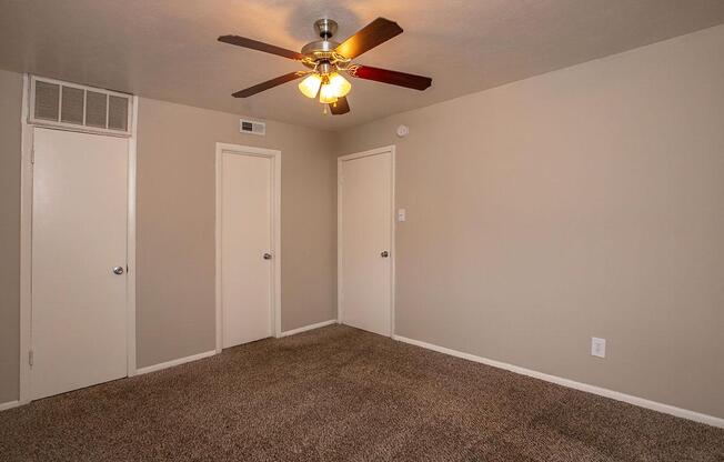 vacant carpeted bedroom with closed doors