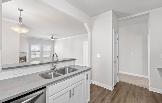 Breakfast bar looking into living room with extra counterspace