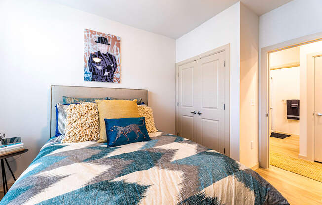 Bedroom with a bed and a door to a bathroom at The Parker Austin, Pflugerville, Texas