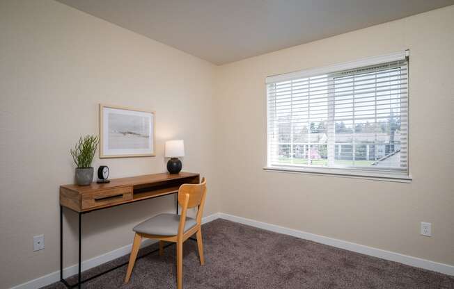 an office with a desk and a window