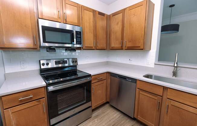 A kitchen with wooden cabinets and stainless steel appliances.