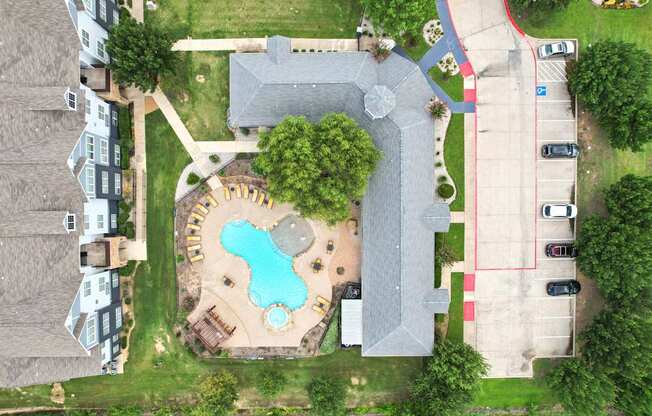 A bird's eye view of a residential area with a swimming pool and a playground.