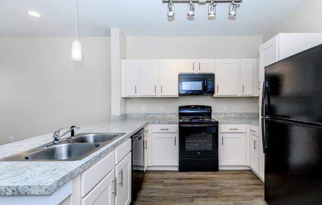 Apartments for Rent in Leander TX - Hills at Leander Spacious Kitchen with Plenty of Counterspace, Fully Equipped with Black Appliances, and Much More