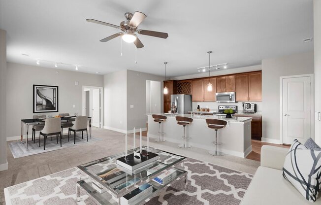 a living room and kitchen with a ceiling fan