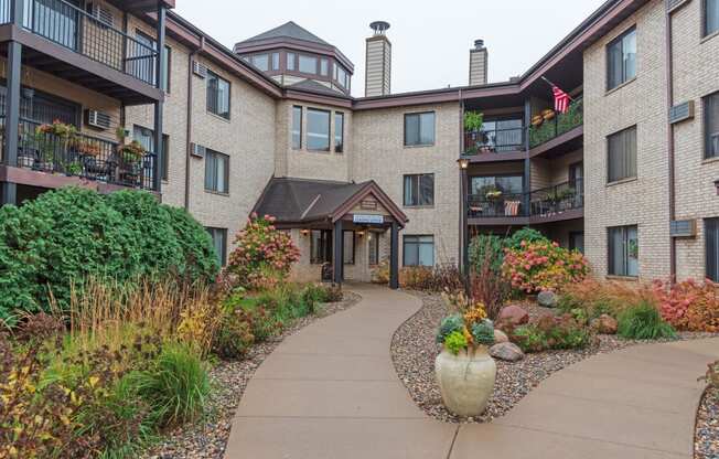 building entrance with lush landscaping