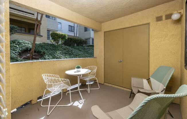 A patio with a table and chairs.