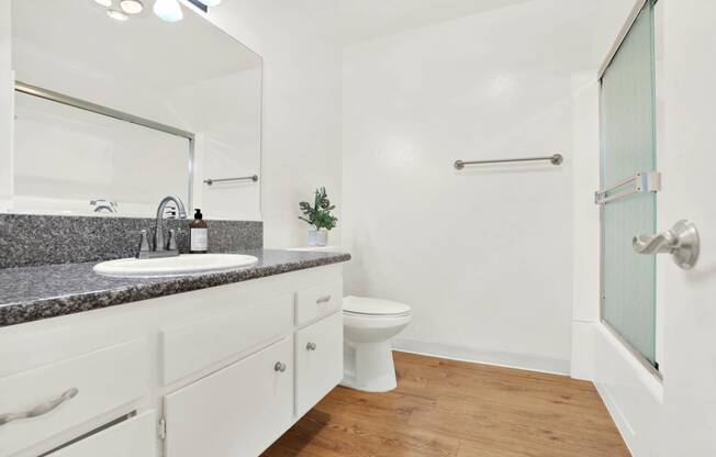 a bathroom with a sink and a toilet and a shower at Casa Del Amo Apartments, Torrance