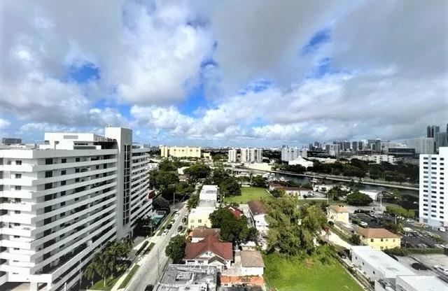 an aerial view of a city with tall buildings