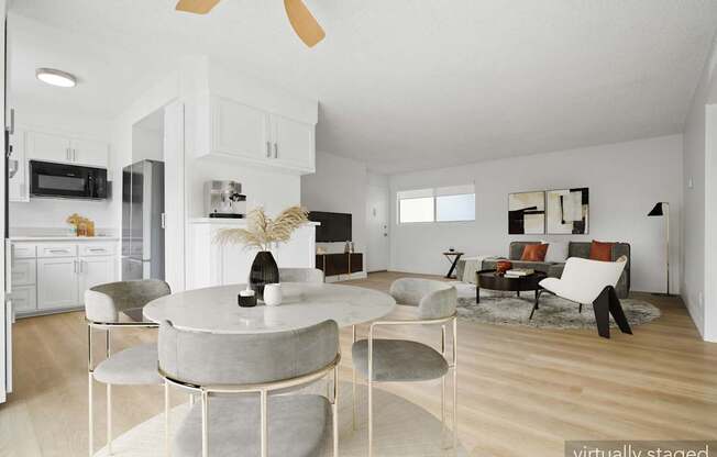 A modern living room with a round table and chairs.