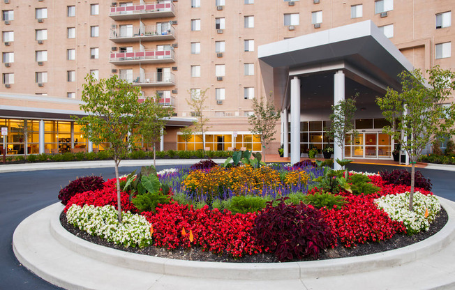 A flower bed in front of a building entrance at Hummingbird Pointe & The Gardens, Parma, OH 44129