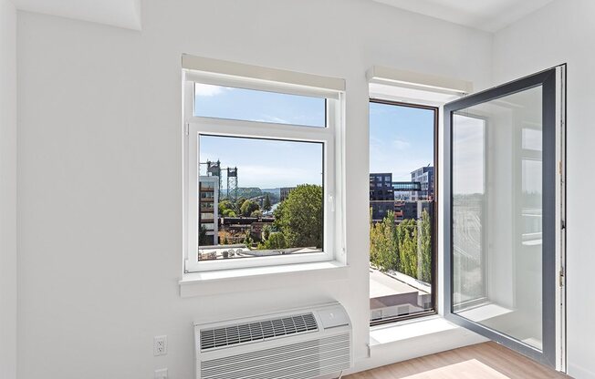 a room with a window and a radiator and a city view