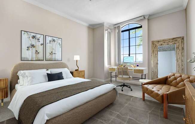 A bedroom with a large bed, a desk with a chair, and a mirror on the wall.