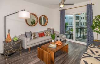 a living room with a couch and a coffee table and a balcony