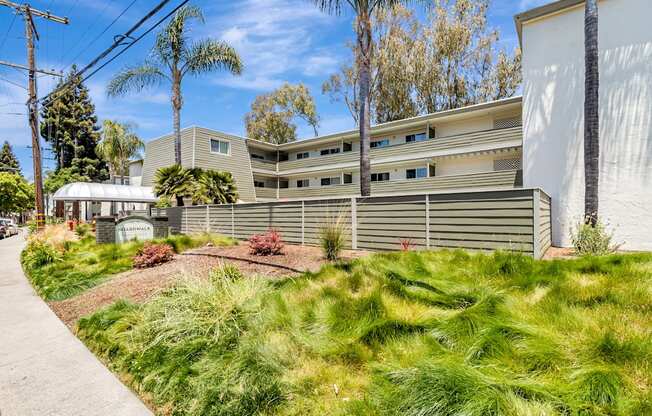 A modern building with a green lawn in front.