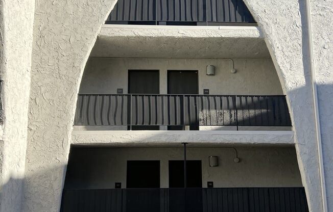 a building with a balcony and a black gate