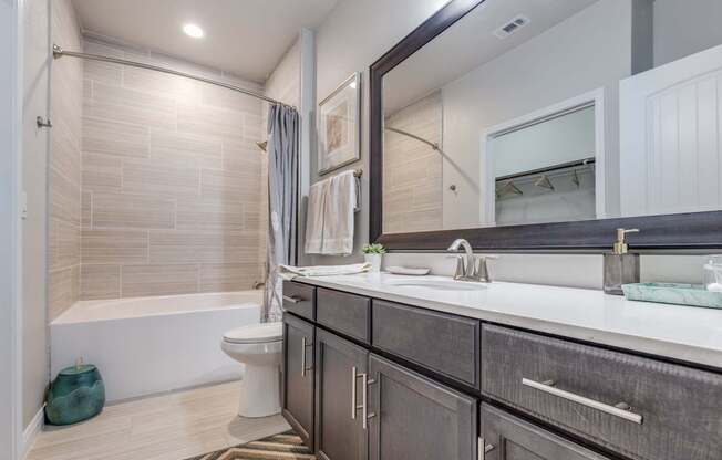 A bathroom with a white tub, sink, and toilet.