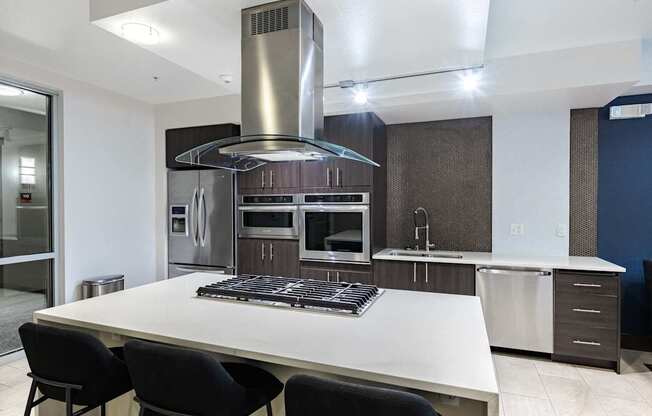 A modern kitchen with a large island and stainless steel appliances. at Kirkland Crossing Apartments, Kirkland