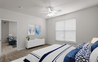 a bedroom with a large bed and a ceiling fan