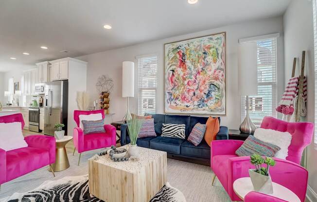 A living room with a large painting on the wall and a zebra print rug on the floor.