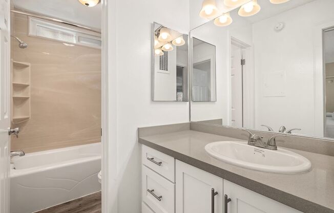 Apartments for Rent in Marina Del Rey, CA - Casa De Maria - Bathroom with Separate Bathtub, Large Vanity Mirror, and Wood-Style Floors