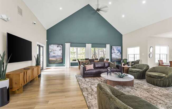 A living room with a green sofa and a wooden floor.