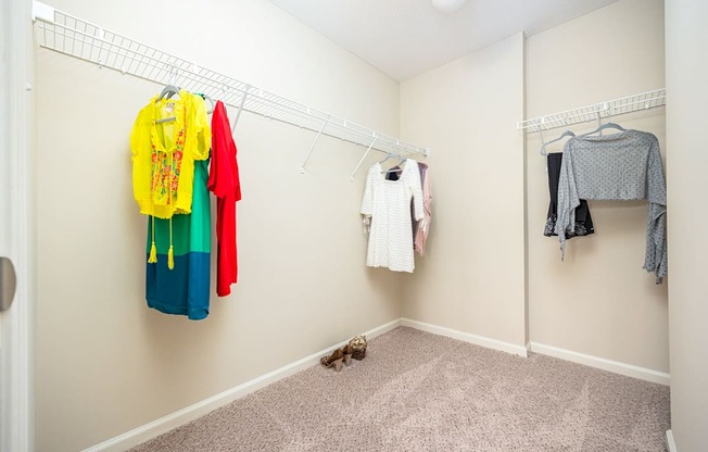 A hallway with clothes hanging on the wall.