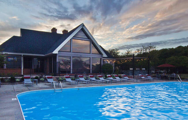 A swimming pool in front of a house.