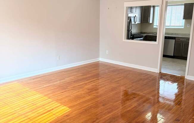 A room with wooden flooring and a ceiling fan.