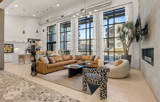 A modern living room with a large sectional sofa and a coffee table. at Bridge at Tech Crossing, Texas