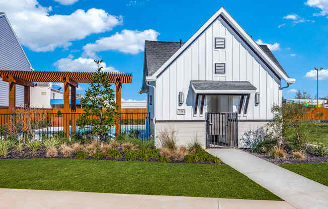a white home with a walkway and a wooden fence