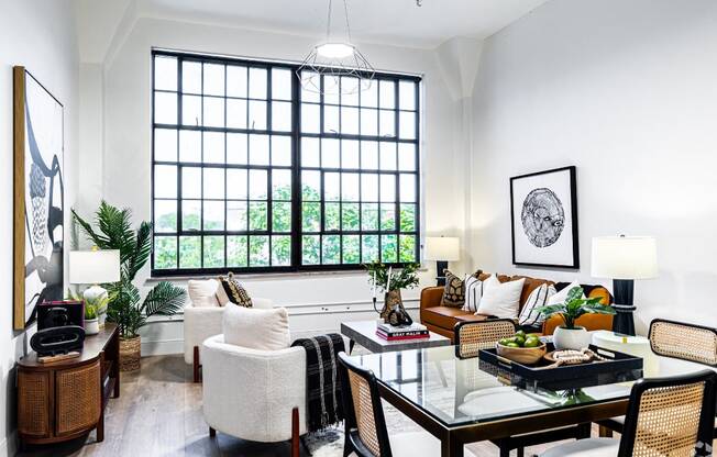 a living room filled with furniture and a large window
