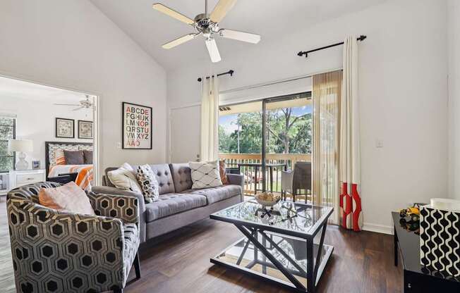 A living room with a couch, chair, and coffee table.