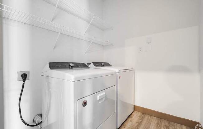 A white washing machine and dryer in a laundry room.