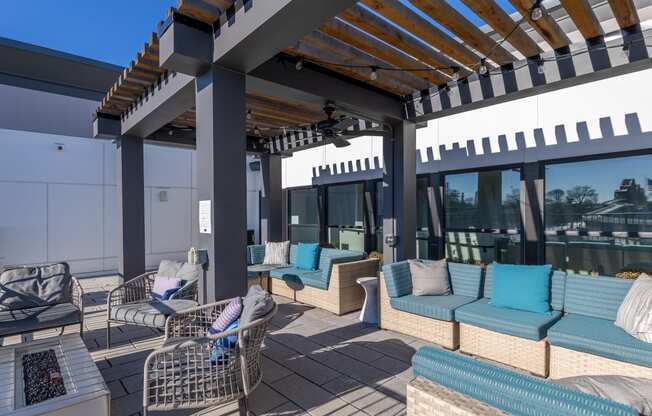 a patio with couches and chairs and a pergola