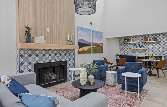A living room with a fireplace and a painting on the wall.
