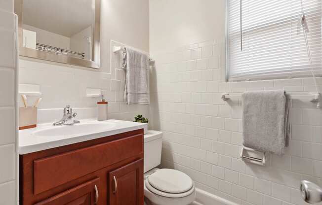 Light filled bath room with cabinet vanity at Donnybrook Apartments, Towson