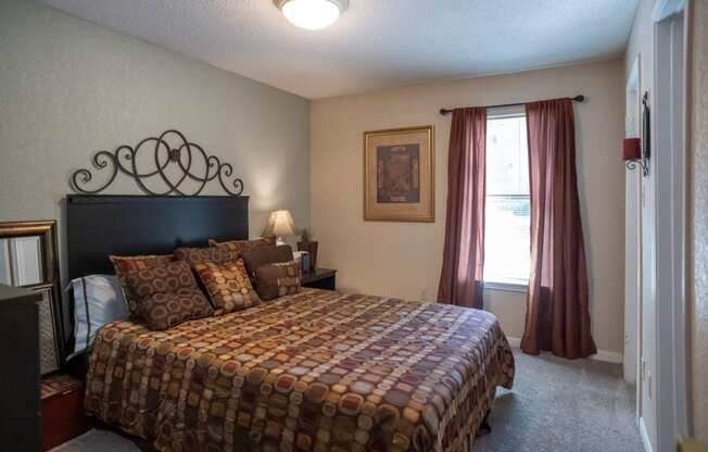 a bedroom with a bed and a window at The Summit Apartments, Memphis, Tennessee