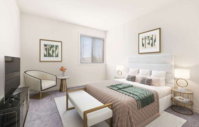 A bedroom with a large bed, a chair, and a TV.