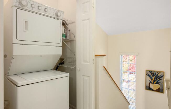 a laundry room with a washer and dryer and a window at Residences at Stevens Pond, Massachusetts, 01906