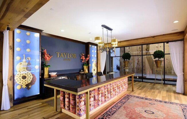 A Taylor branded kitchen with a black counter top and a wooden floor.