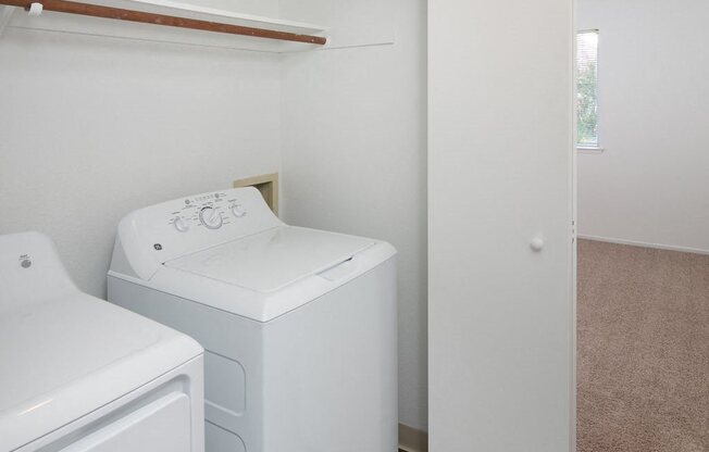 Full Sized In Unit Washer and Dryer With a Closet, Folding Doors, and Shelves for Extra Storage at Laurel Creek, California, 94533