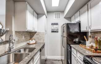 a kitchen with stainless steel appliances and granite counter tops