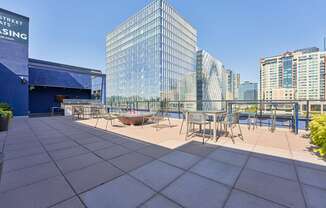 a terrace with tables and chairs on top of a building