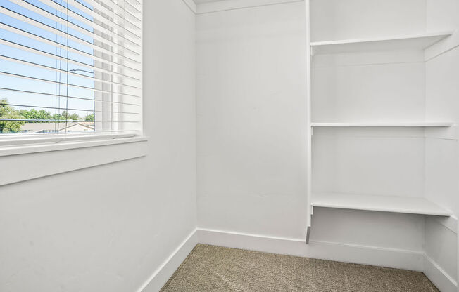 a corner of a room with a window and white shelves  at Aero Luxury Townhomes in Layton, Utah
