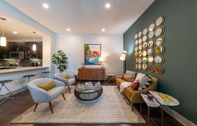 A modern living room with a grey sofa, yellow armchair, and a coffee table.