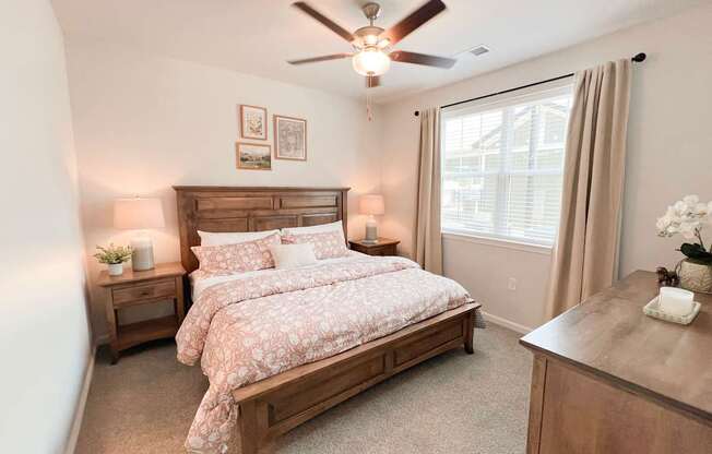 Pet-Friendly Luxury Apartments In Boiling Springs, SC - Grande At Geyser Falls - Carpeted Bedroom Featuring A Large Bed And A Ceiling Fan