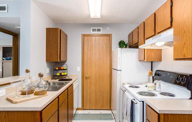 A kitchen with wooden cabinets and a white refrigerator.