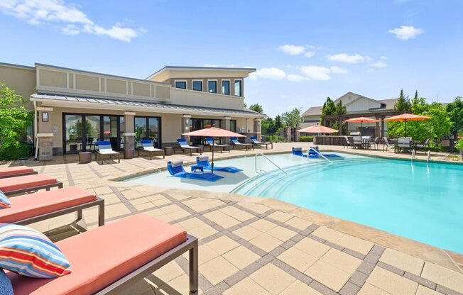 a swimming pool with lounge chairs and umbrellas