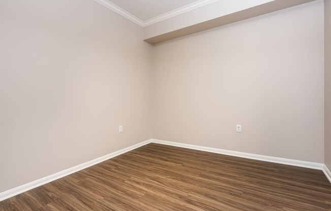 an empty room with wood style flooring